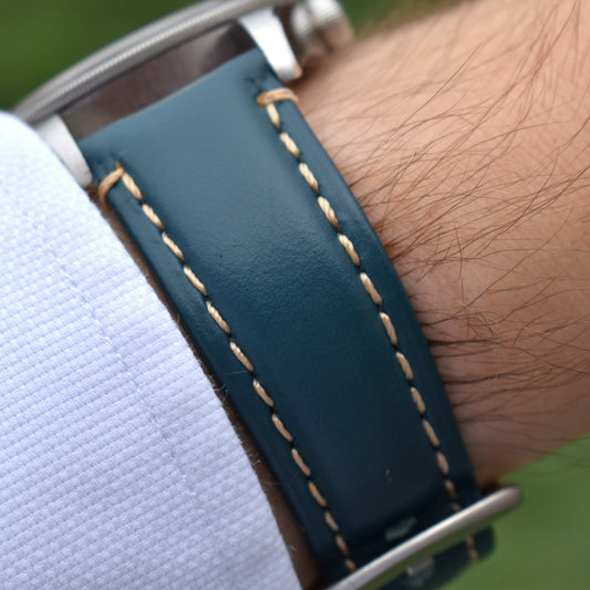 Wrist shot of the Oslo petrol blue full grain leather apple watch strap. Placed on the Tudor Blackbay 58 on a males wrist.