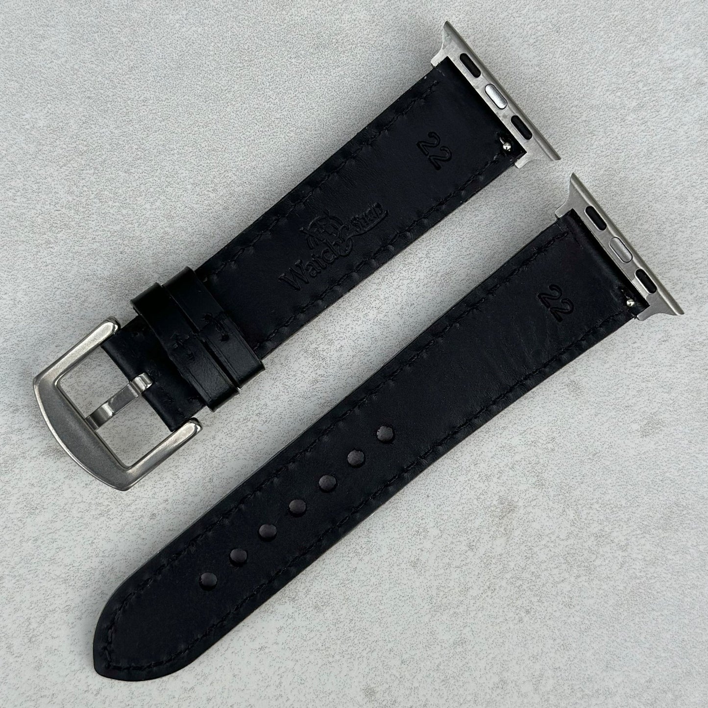 Underside of the Athens jet black full grain leather watch strap. Watch And Strap logo debossed into the rear of the strap.