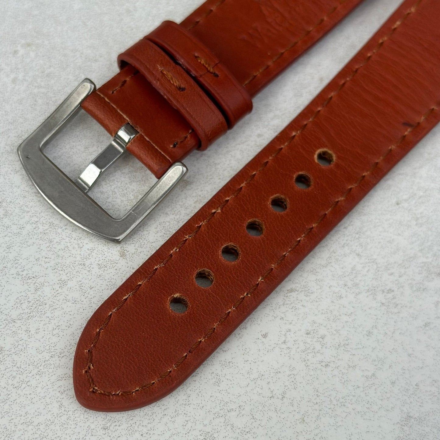 Underside 316L stainless steel buckle of the Athens burnt cinnamon full grain leather watch strap.