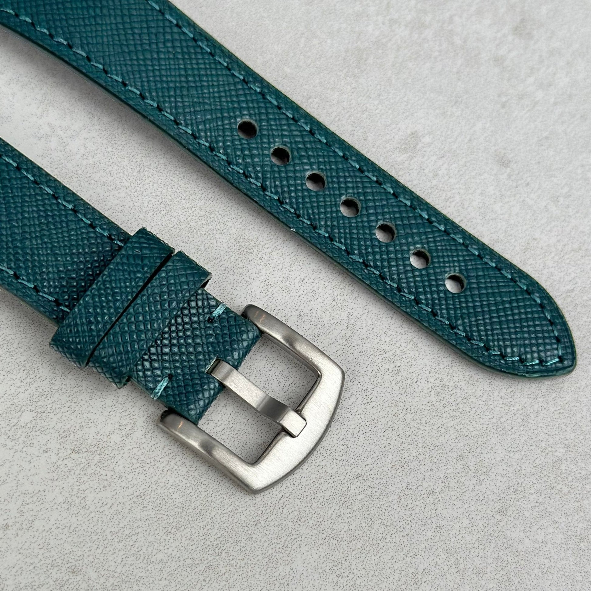 Brushed 316L stainless steel buckle on the Florence teal Saffiano Leather Apple Watch strap.