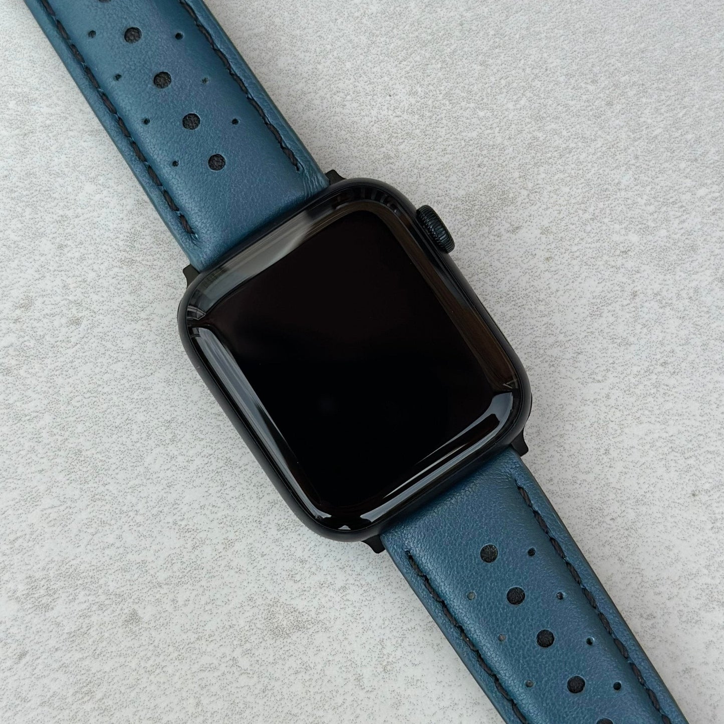 Le Mans petrol blue and black full grain leather apple watch strap on an Apple watch.