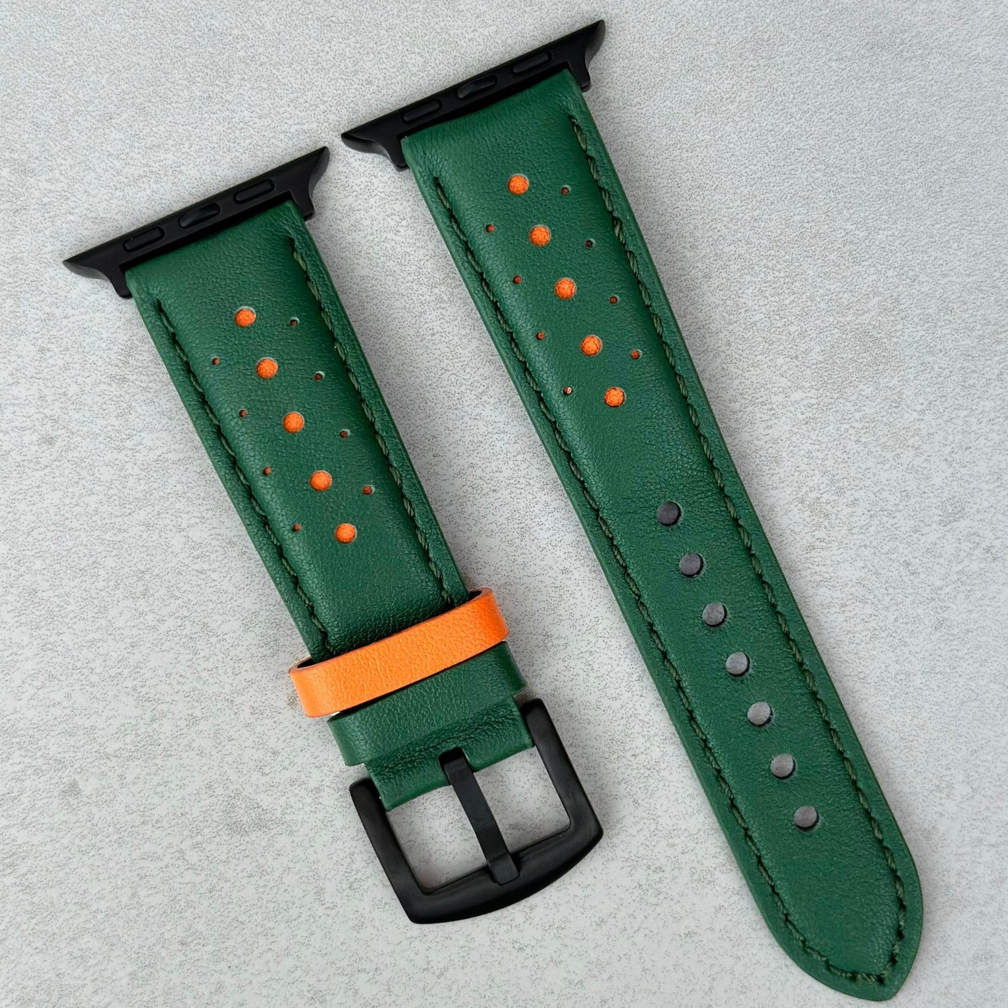 Le Mans green and orange full grain leather apple watch strap. PVD black stainless steel hardware.