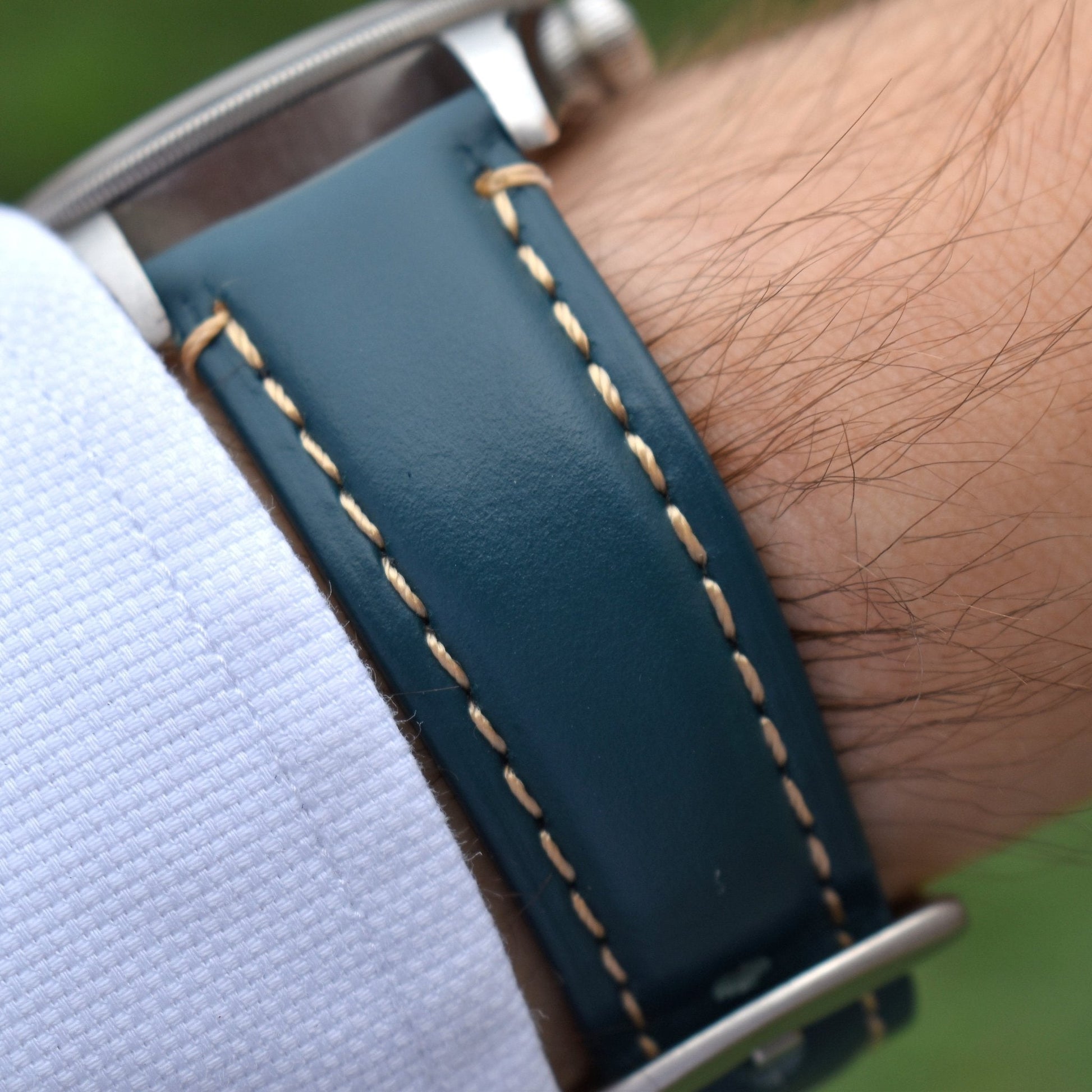Wrist shot of the Oslo petrol blue full grain leather apple watch strap. Placed on the Tudor Blackbay 58 on a males wrist.